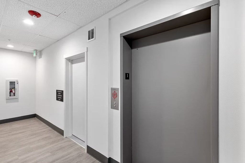 A modern elevator and lobby area in an apartment building, highlighting a key amenity in properties managed by DSM Sophia.