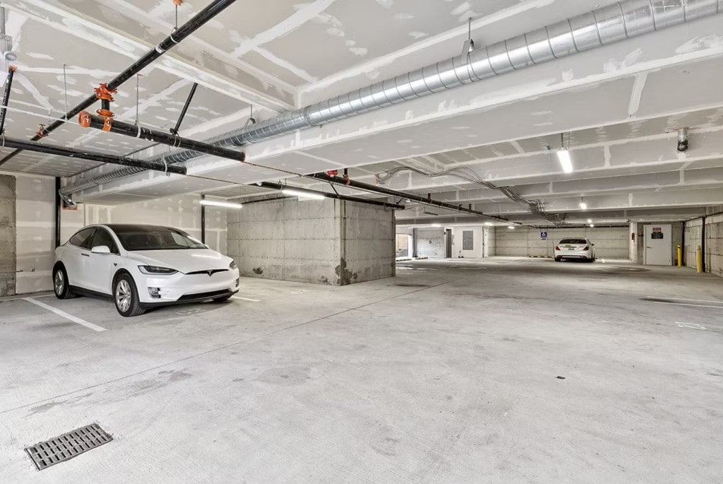 A clean, secure underground parking garage in a managed apartment building, illustrating a key feature for tenants.
