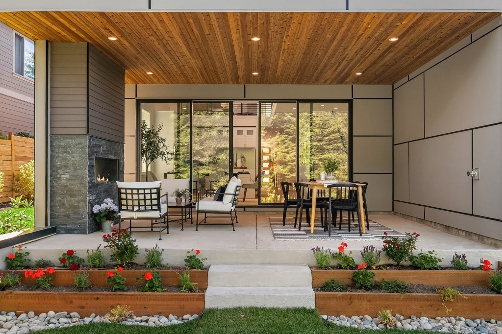 A seamless indoor-outdoor living space with a covered patio, featuring modern dining and lounge furniture, perfect for entertaining.