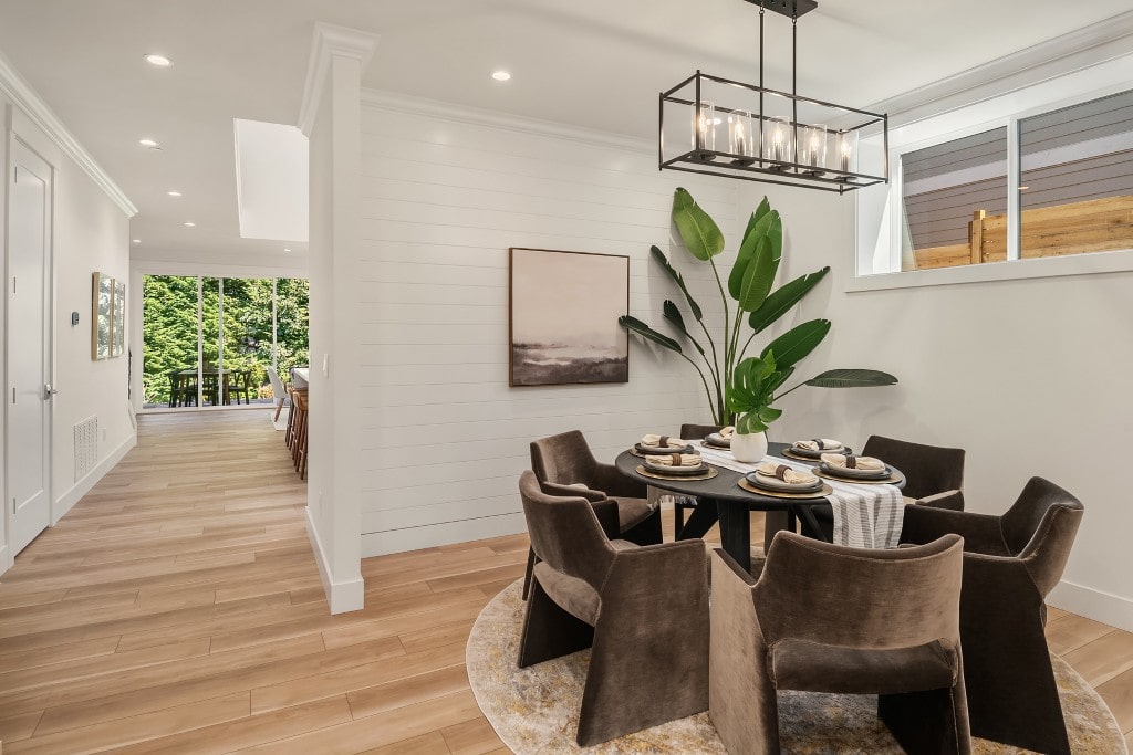 A contemporary dining area with a black round table and upholstered chairs, highlighting a stylish interior design in a Bellevue home.
